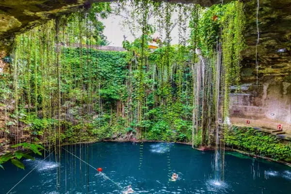 Cenote Ik Kil natural swimming hole with hanging vines and turquoise water