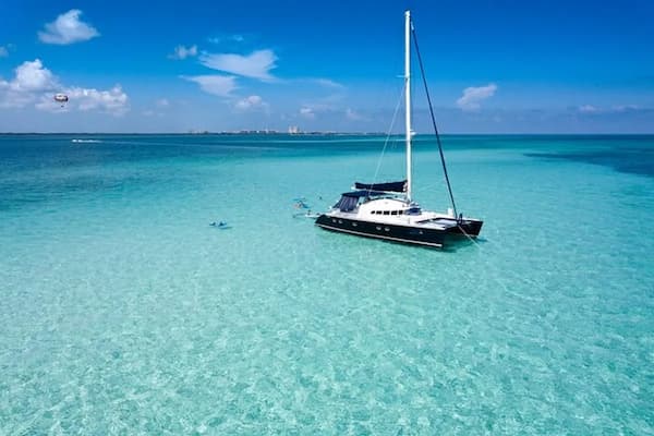 Catamaran sailing on turquoise waters near Puerto Morelos